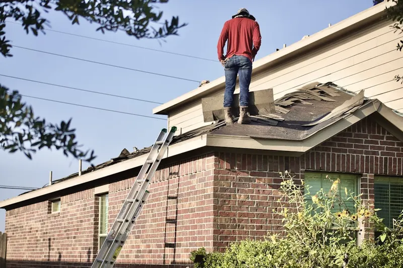Professional roofer working on a residential roof in Lederach